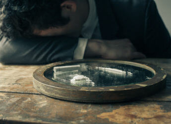 Young businessman is feeling unwell after doing cocaine